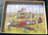 This wooden "Victory" jigsaw puzzle in the 'Topical Series' of "Spitfires in Flight", was made in England by G. J. Hayter and Co. Ltd., Boscombe, Bournemouth, and shows 41 Squadron aircraft. It originally cost 5/9 (five shillings & nine pence), including purchase tax (ca. 28p in modern UK currency). This magnificent collectors' item was purchased recently (July 2004) by Allan Hillman <allan.hillman@btinternet.com>, who is also the source of this picture. [Note the incorrect camouflage colour chosen by the artist/manufacturer]